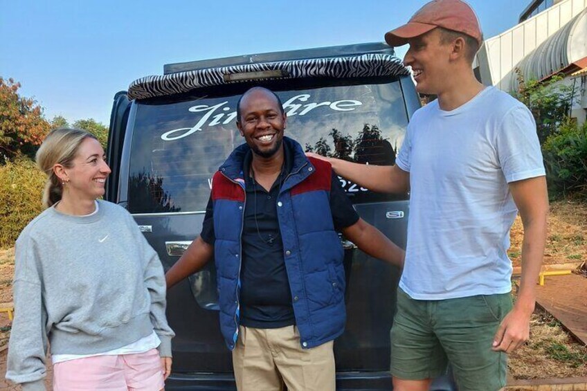 Three people standing in front of a vehicle with a zebra-striped hood and the word 'Jungle' on it. 3