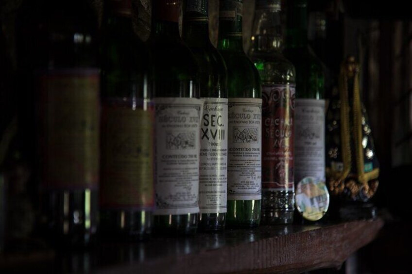 A row of wine bottles on a shelf. 3