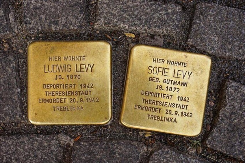 Two gold plaques on a stone surface with inscriptions. 3