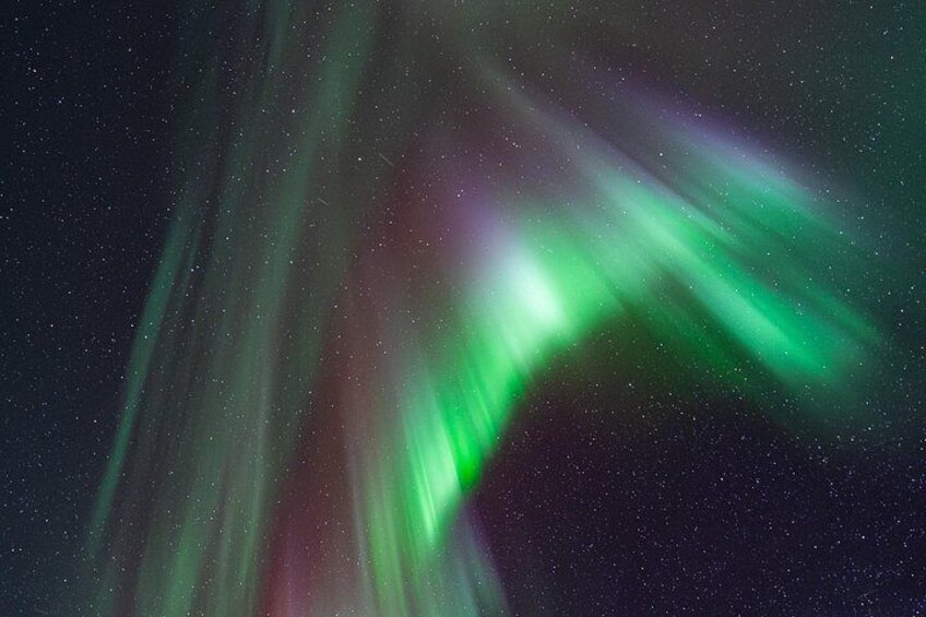 The Northern Lights (Aurora Borealis) with green and red hues. 4
