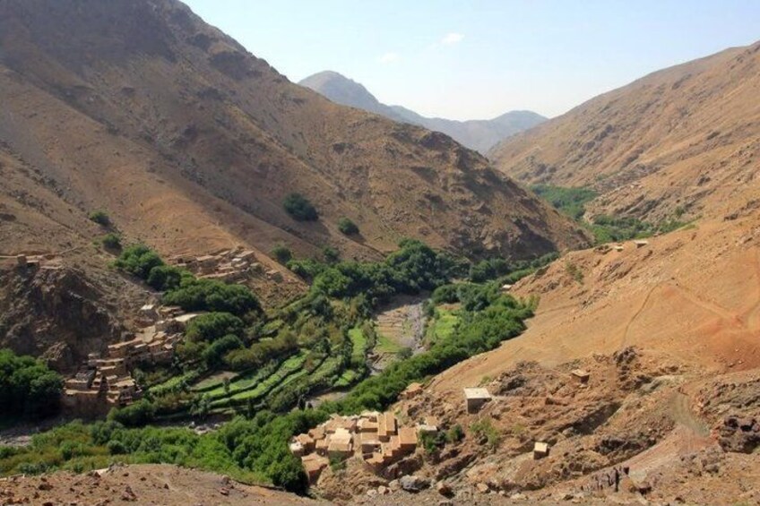 A mountainous landscape with terraced fields and ancient ruins. 2