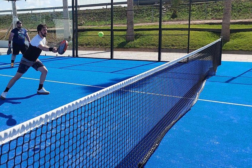 A tennis court with two players in action. 3