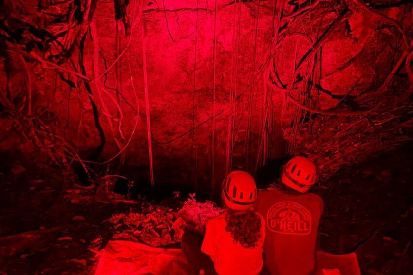 A cave with red lighting, a helmet, and a helmet with the O'Neill logo. 4