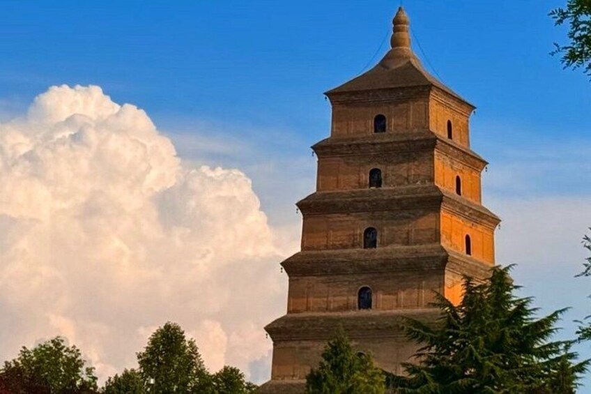 A multi-tiered pagoda with a clear sky and clouds in the background. 1