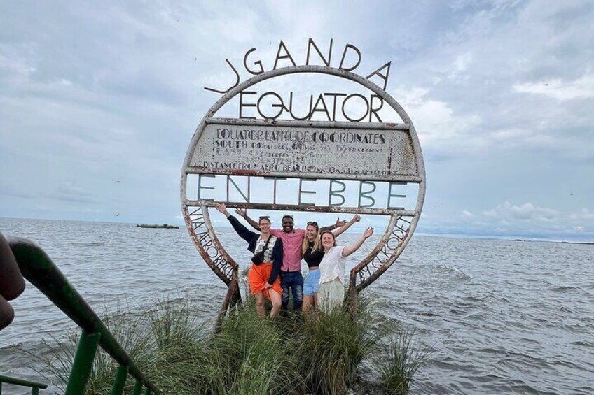 A sign with 'JAGANDA EQUATOR' written on it, surrounded by water. 4