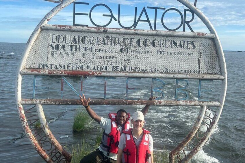 A metal sign with 'EQUATOR' written on it, indicating the equatorial line. 3