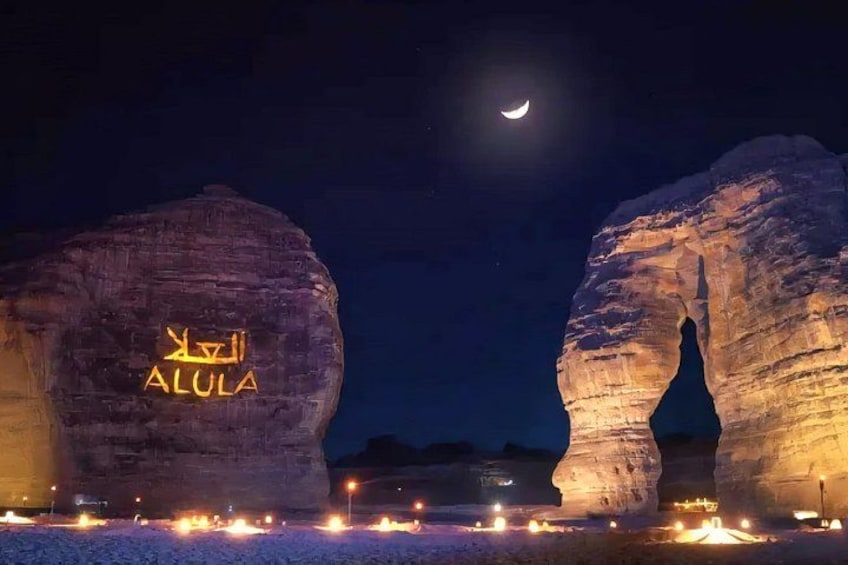 Illuminated rock formations with the text 'ALULA' and a crescent moon in the sky. 4
