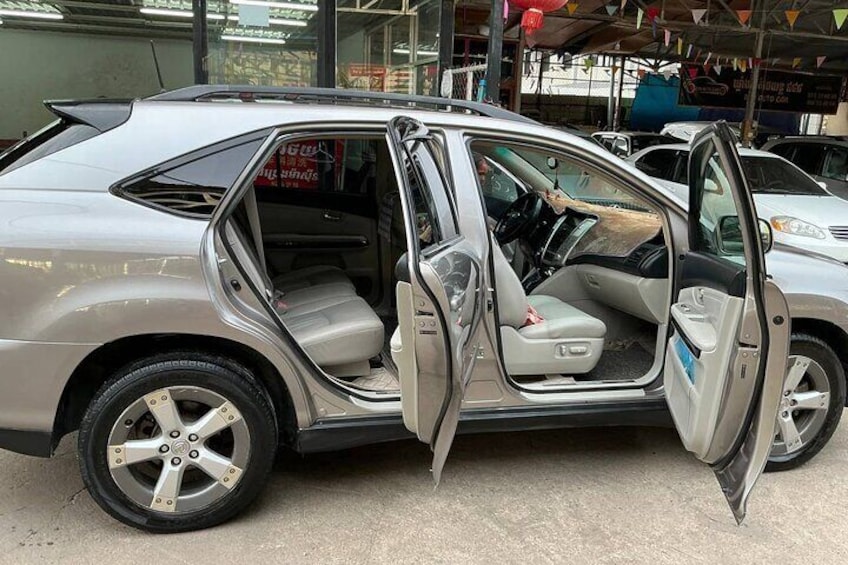 A silver SUV with its doors open, parked in an indoor lot. 4