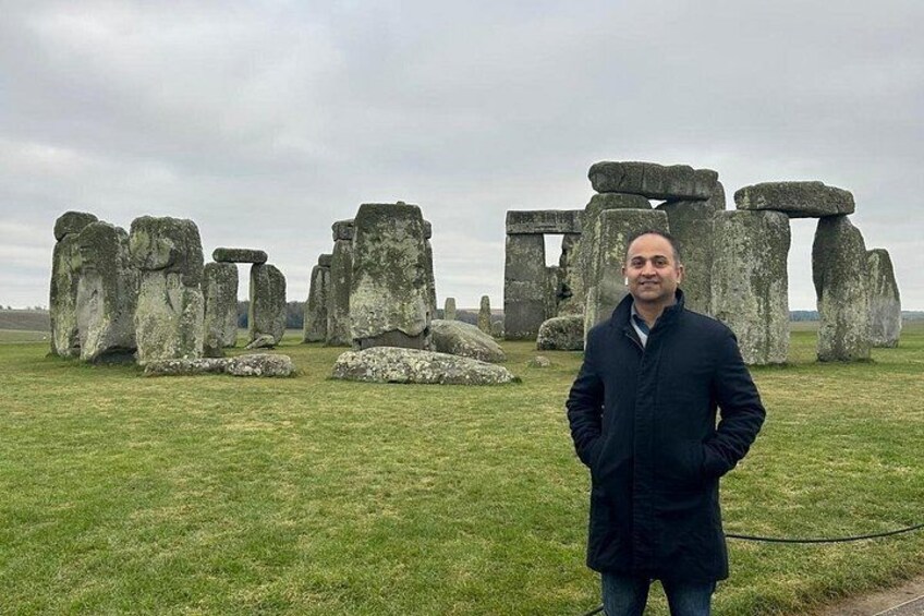 Stonehenge standing in a grassy field. 4