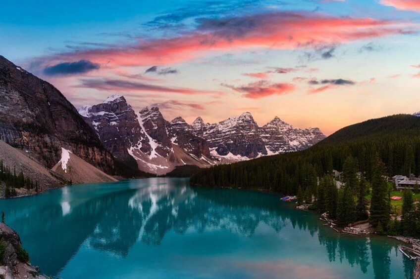 A mountain range, a turquoise lake, and a forested area. 3