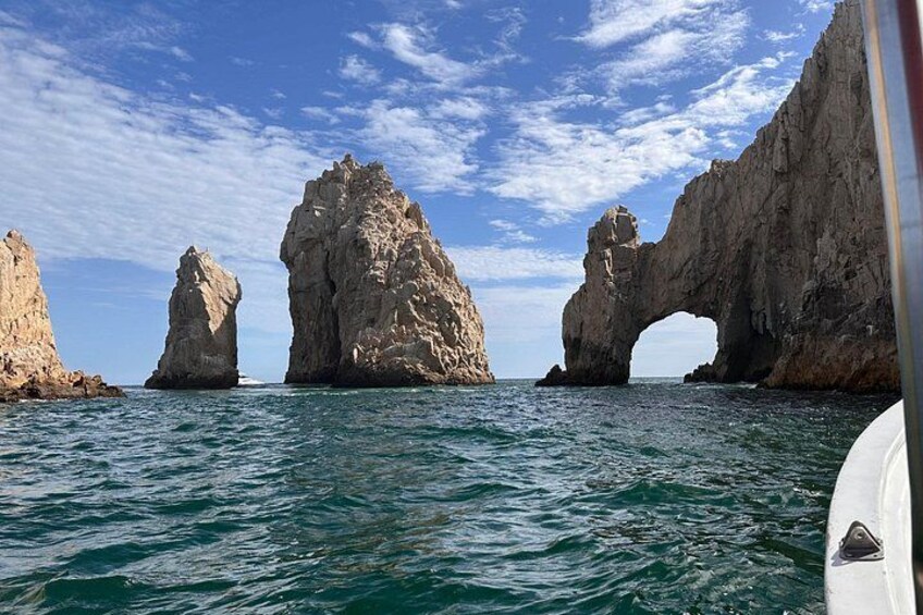 A boat with rocky formations and a clear sky. 2