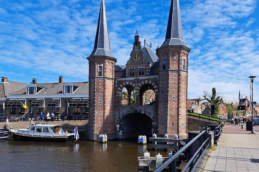 A historic bridge with two towers, a boat docked in the water, and a pedestrian walkway. 4