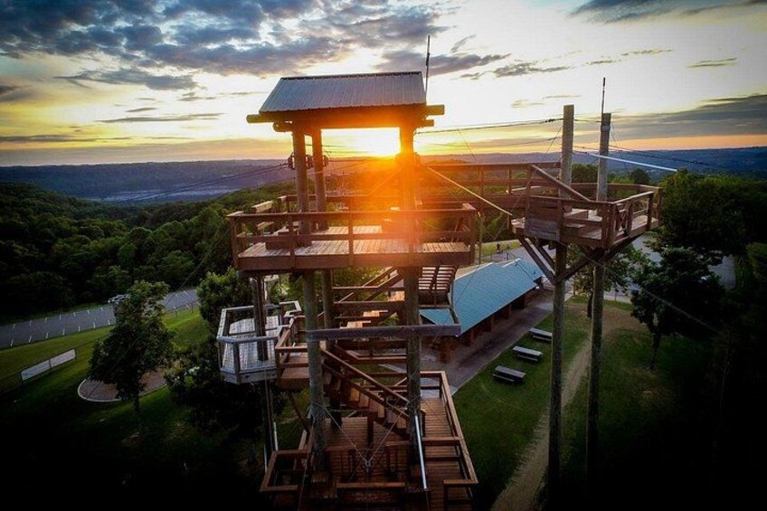 A wooden observation tower with a metal roof overlooking a valley. 2