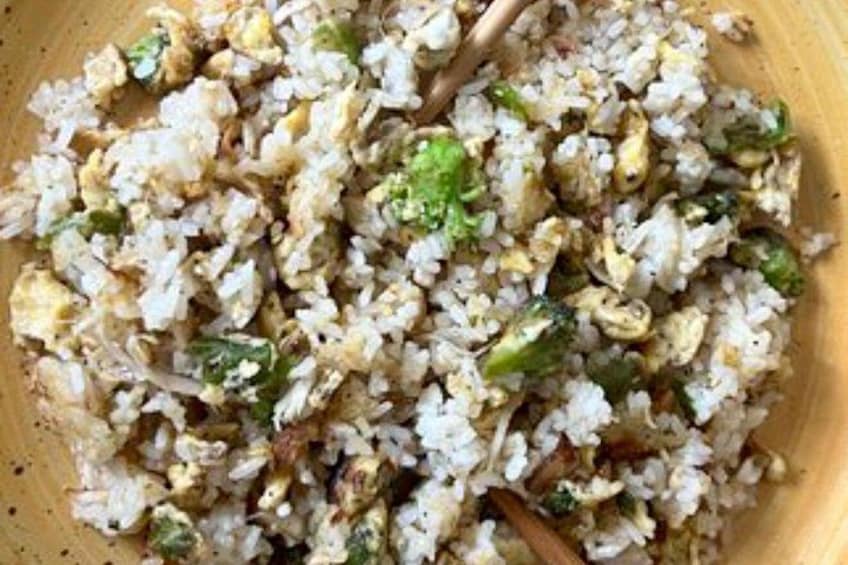 A close-up of fried rice with vegetables and scrambled eggs. 3