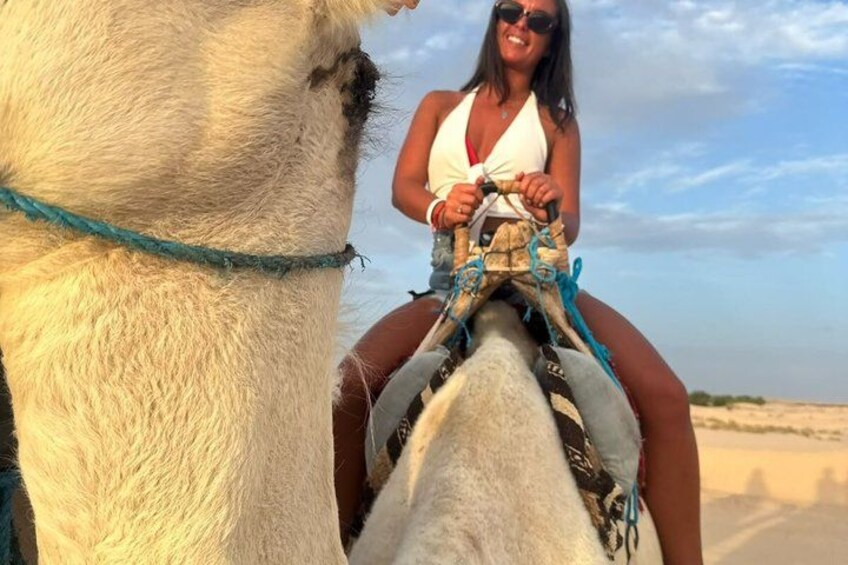 A person riding a camel on a beach. 2