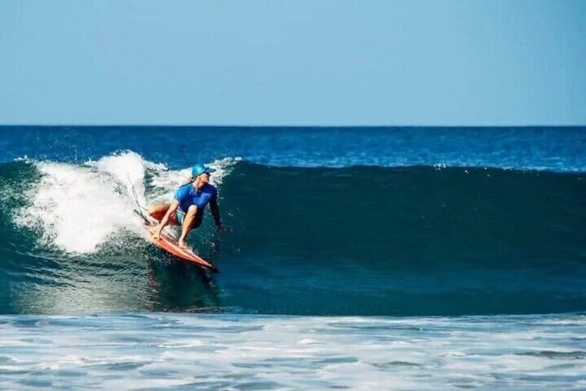 A person surfing a wave in the ocean. 4