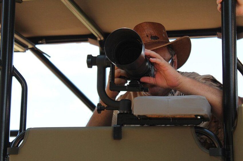 A person using a large telescope mounted on a vehicle. 4