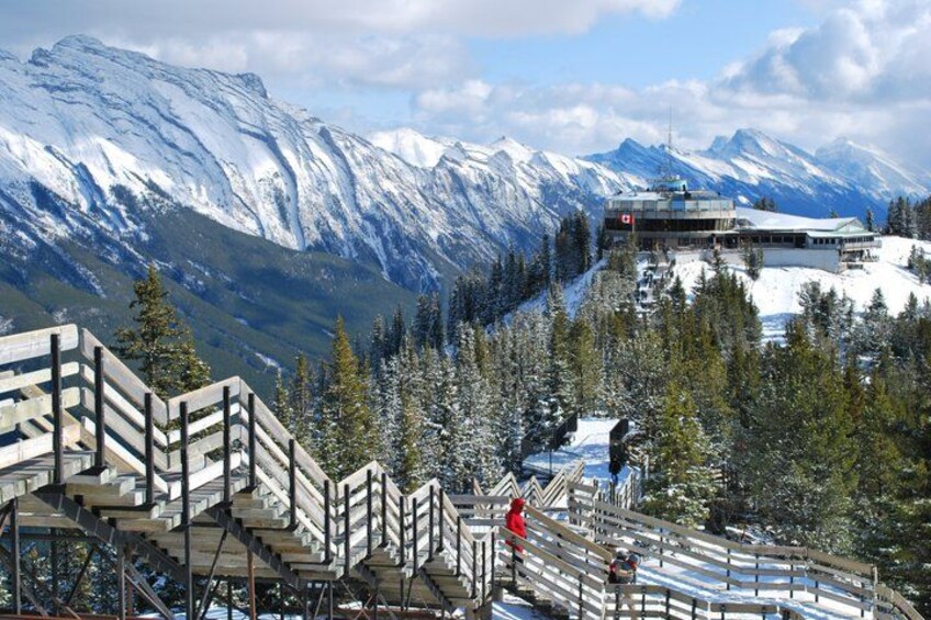 A snow-covered mountain landscape with a ski lift and a lodge. 5