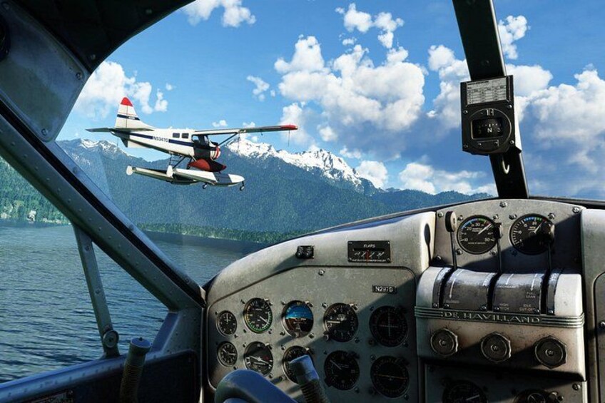 A helicopter flying over a lake with mountains in the background. 3