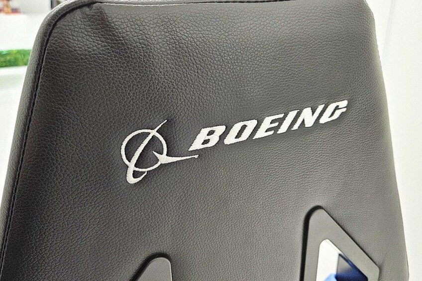 A black leather chair with the Boeing logo embroidered on it. 4