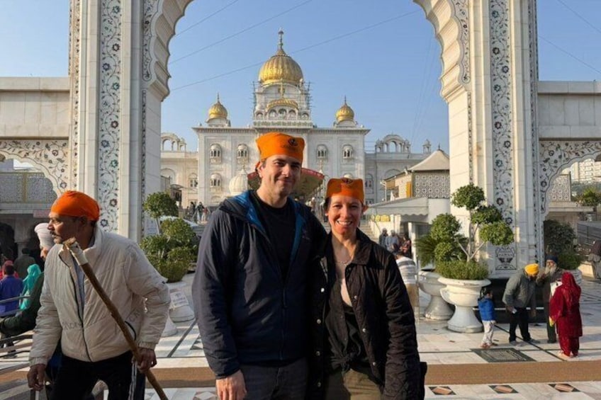 A group of people in front of a large, ornate building with domes and intricate architecture. 5