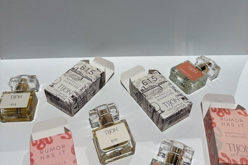 Various bottles and boxes of TISON cologne with the number 615. 2