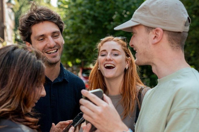 A group of people standing outdoors, engaged in conversation. 3