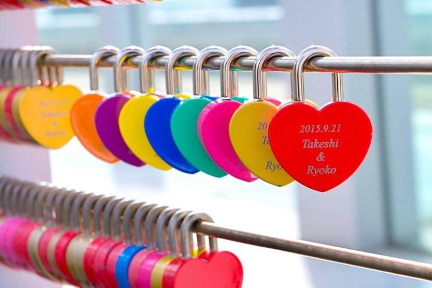 A series of heart-shaped tags with dates and names, hanging on a metal rack. 4