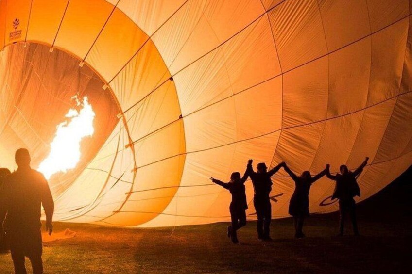 A hot air balloon with people inside, preparing for a flight. 3