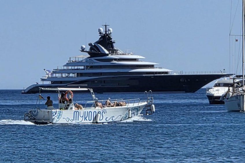 A large yacht with a smaller boat in the foreground. 2