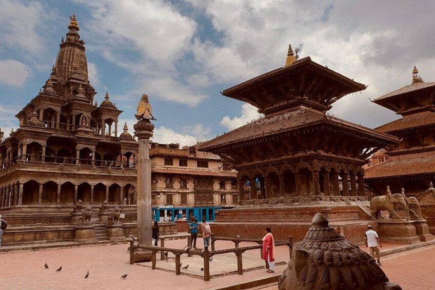 A historical temple complex with intricate architecture, including a large stupa and multiple smaller structures. 1