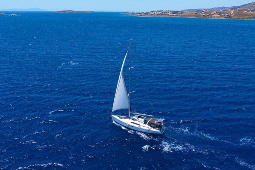A sailboat on a blue sea with a clear sky. 1