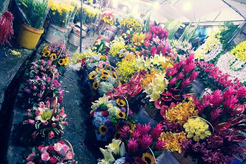 A flower market with various colorful flowers on display. 2