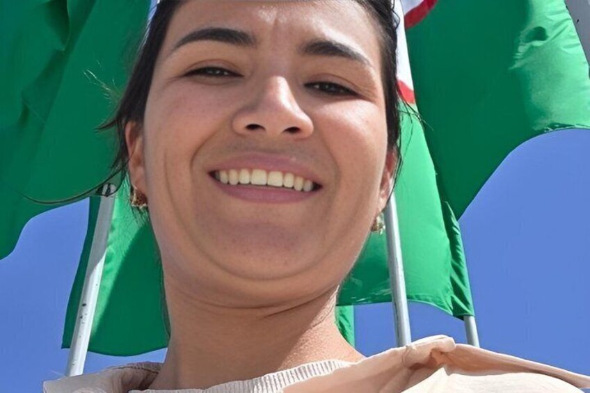 A person holding a green flag with a white stripe. 2