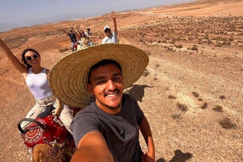 A group of people on a desert landscape with sparse vegetation. 2