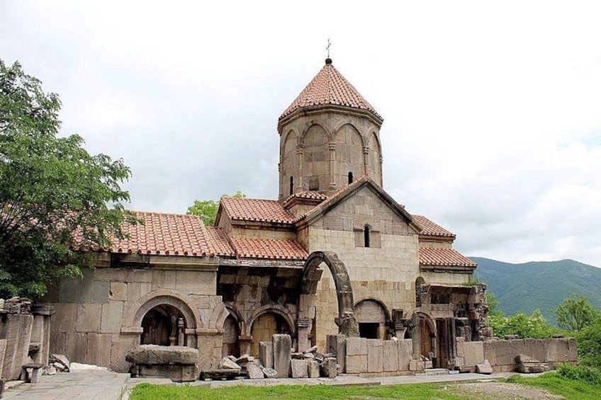 A historic church with a bell tower, arched windows, and a stone facade. 2