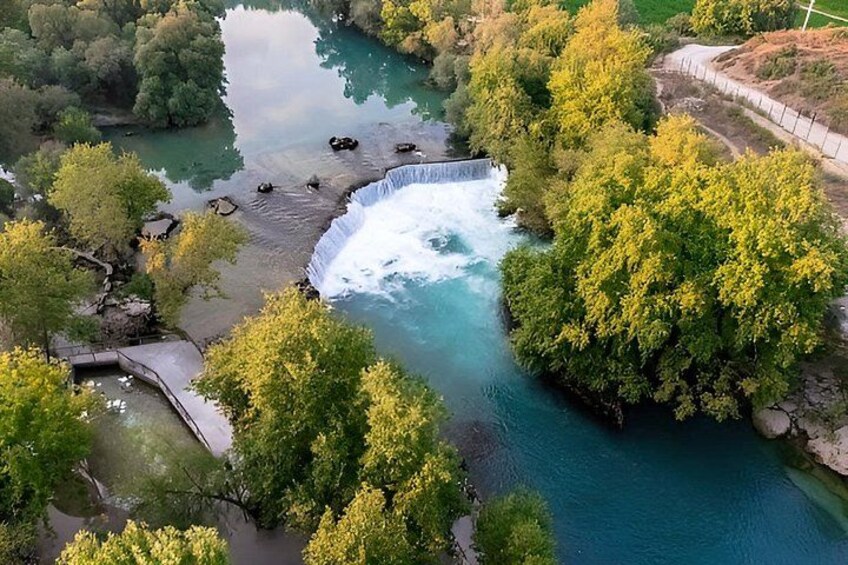 A waterfall, river, and surrounding forest. 3