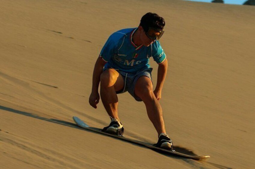 A person surfing on a sandy beach. 4