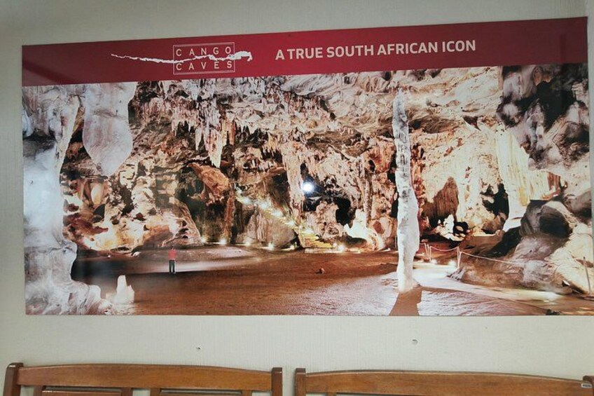A cave interior with stalactites and a wooden platform. 4