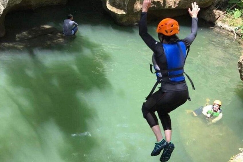 A person bungee jumping from a bridge into a river. 5