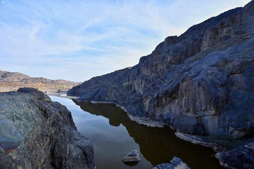 A river flowing through a canyon with rocky cliffs. 2