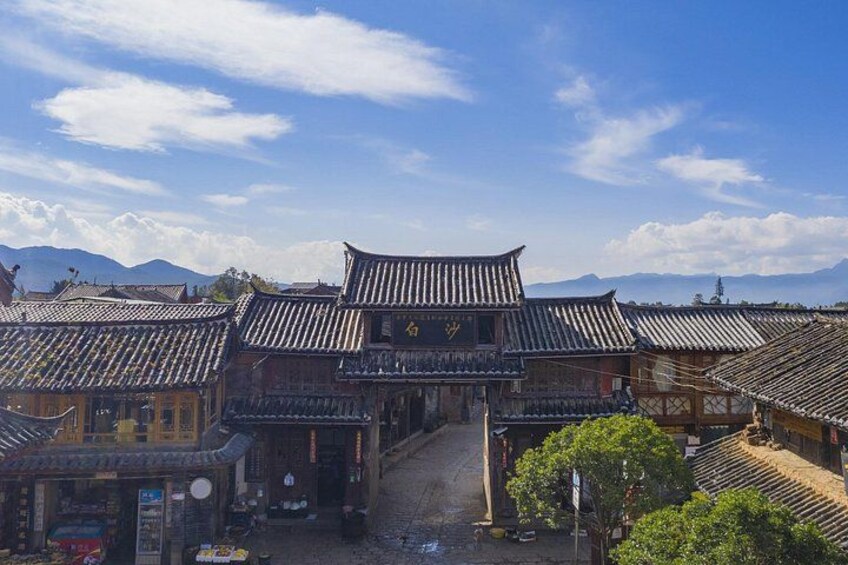 A traditional Chinese courtyard with tiled roofs and wooden buildings. 3