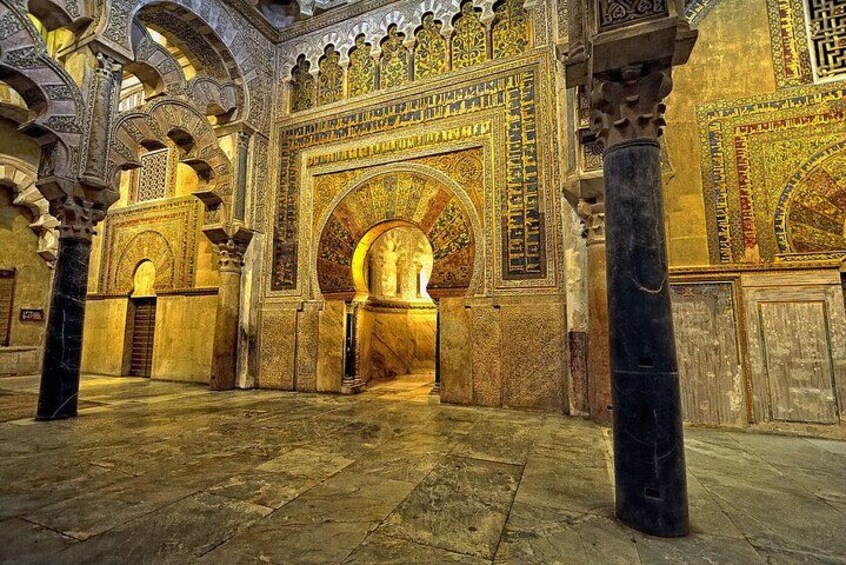 An interior with arches, columns, and detailed wall patterns. 2