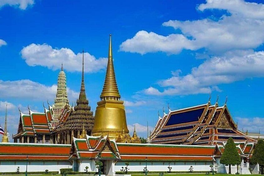 A temple complex with multiple golden spires and traditional Thai architecture. 1