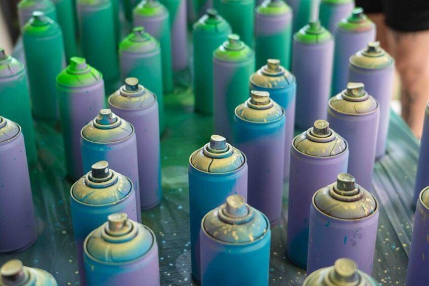 A collection of spray paint cans in various colors. 3