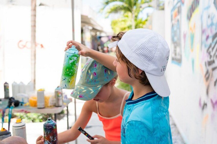 Two people painting on a wall. 4