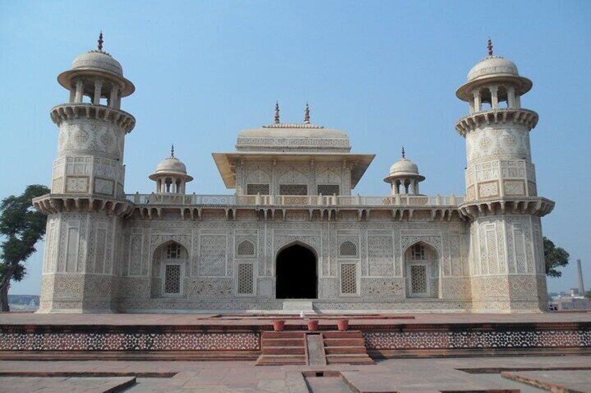 A large, ornate building with four domes and two minarets. 1