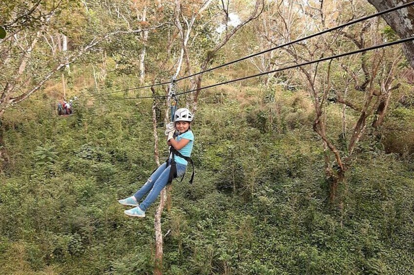 A person zip-lining through a forest. 2