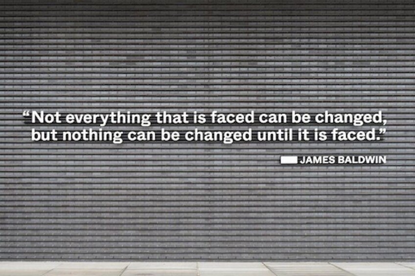 A quote on a brick wall. 3