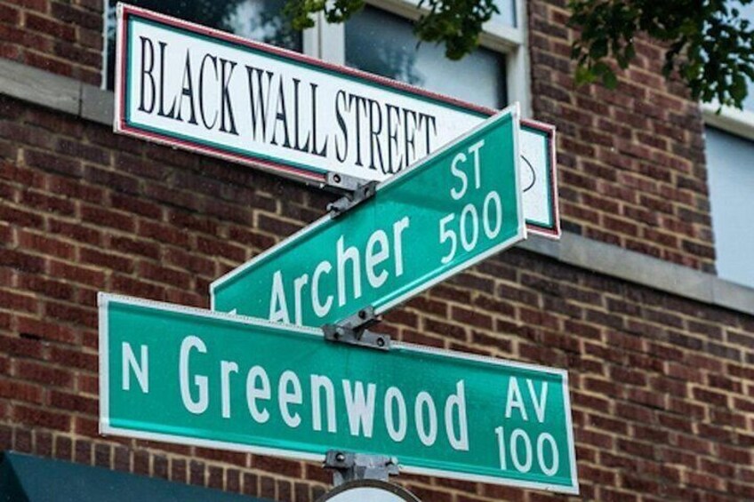Street signs for Black Wall Street, Archer St, and N Greenwood Av. 1